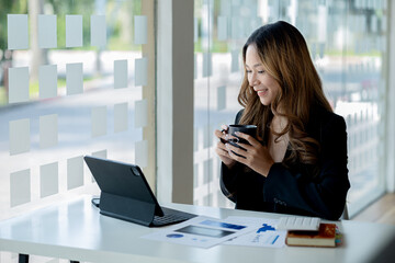 Beautiful Asian woman is a businesswoman who leads a new generation of startups, a woman who runs and manages a business plan to build confidence and stability in business, woman-led business concept.