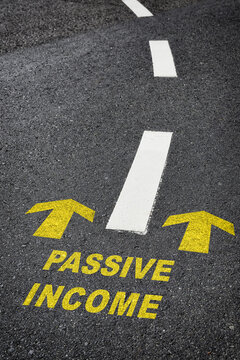 Passive income with yellow arrow marking on road. Making money  retirement concept and motivation to success idea