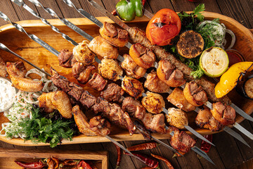 Assorted grilled caucasian shashlik kebabs on the wooden board