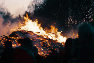 silhouette of people in front of easter bonfire