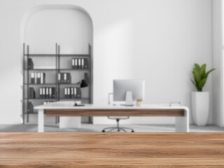 Wooden desk on blurred background of boss room interior. Mockup