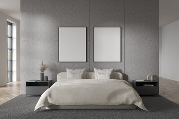 Bright bedroom interior with bed, two empty white posters