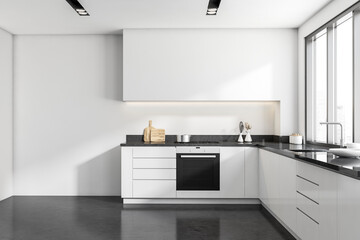 Front view on bright kitchen interior with empty white wall - obrazy, fototapety, plakaty