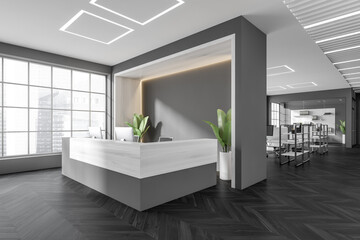 Corner view on dark office reception interior with desktops