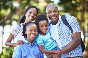 They share a love of nature. Portrait of a happy african american family enjoying a day out in the...