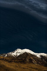 Snow covered peaks with clouds