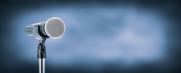 Microphone with stage light background for performance concept of speech comment and public speaking