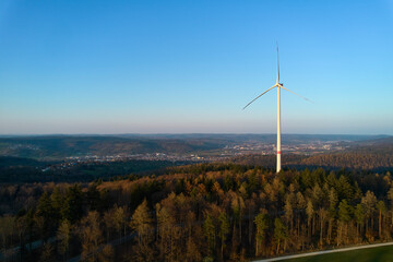 A wind turbine in the forest. Alternative energy to expensive gas and oil. Germany, Winterbach.