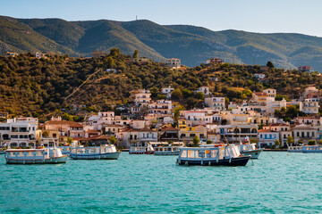 View on many boots and vintage buildings in Galatas, Greece, from the water (Stenon Porou) near half island Poros