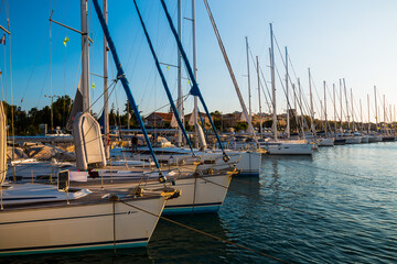 A row of sailing yachts staying in the marina Lavrion, Greece, on anchor and waiting for their...
