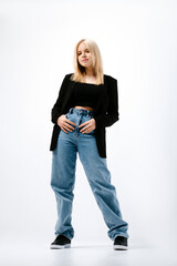 Naklejka premium Full length portrait of hipster girl in wide jeans and black jacket