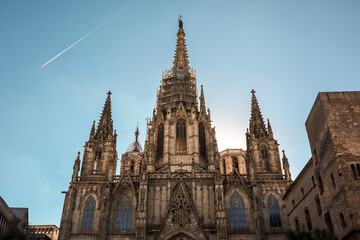 Fototapeta na wymiar The Cathedral of the Holy Cross and Saint Eulalia in Catalonia. Architecture of Barcelona Cathedral with Blue Sky.