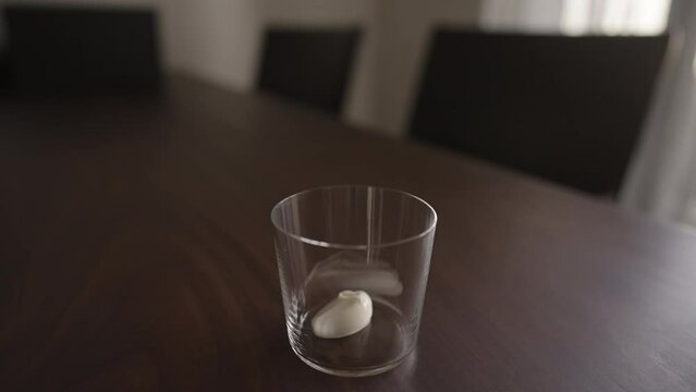 add yogut in tumbler glass on wood table