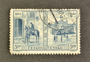 Cancelled postage stamp printed by Czechoslovakia, that shows Mounted postman and mail van, 75th Anniversary of Universal Postal Union, circa 1949. - obrazy, fototapety, plakaty