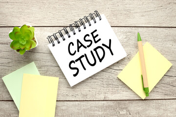 Case Study text on open notebook near green stickers and yellow