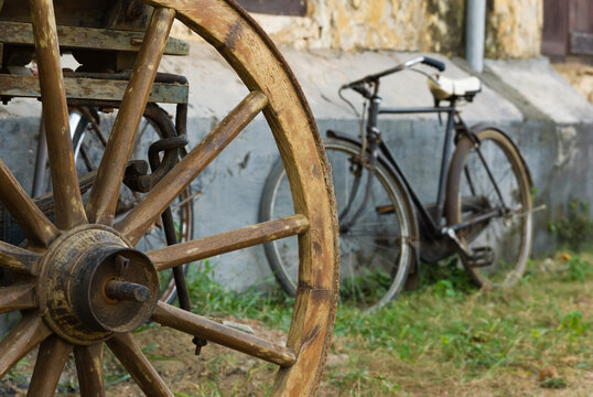 Bulllock carth wheel and old rusty bicycle