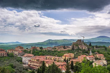 Foto op Canvas Green landscape in Tuscany, Italy. Unique view of medieval village and stone tower perched on rock cliff against dramatic sky. © fabio lamanna