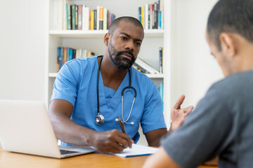 Mature african american doctor talking with patient