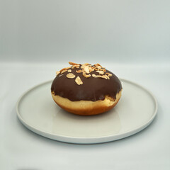 Donut with chocolate icing on white isolated background.