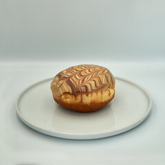 Chocolate donut on a plate on wihte isolated background.