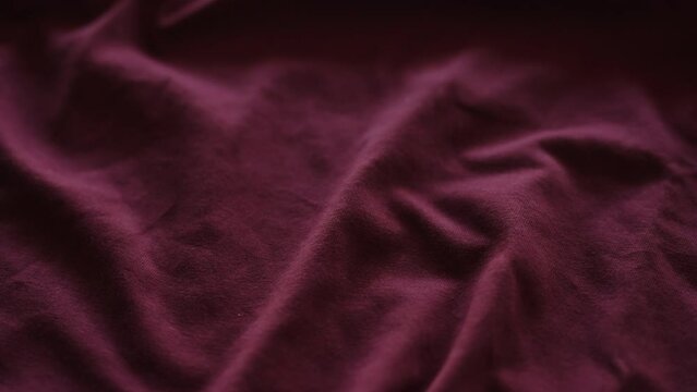 Slow motion handheld shot of purple cotton fabric