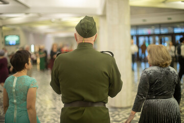 Old man at meeting of graduates. Seniors at event. Dancing friends.