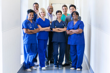 Smiling portrait male female multi ethnic specialist surgical team in hospital
