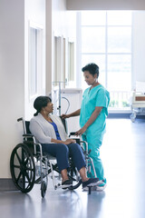 African American female nurse and disabled wheelchair patient medical centre