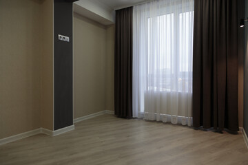 An empty newly renovated room with light Wallpaper.