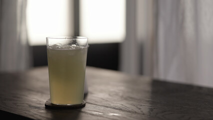 lemonade in tumbler glass with crushed ice on wood table
