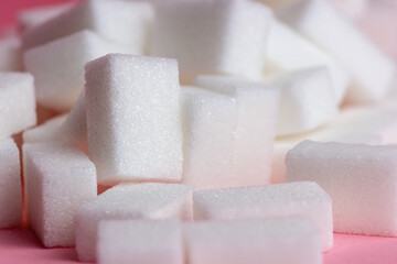 sugar cubes on a pink background.