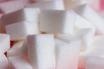 sugar cubes on a pink background.