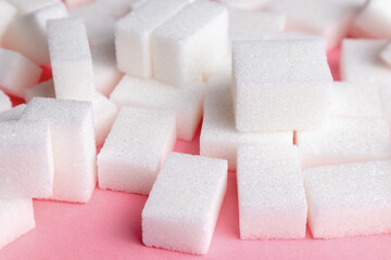 sugar cubes on a pink background.