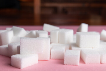 sugar cubes on a pink background.