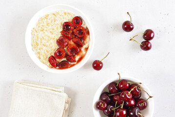 Oatmeal porridge with cherry slices in bowl