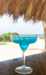 blue vodka cocktail at the beach bar in summer