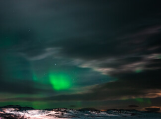 Landscape. The Northern lights in the sky beyond the Arctic Circle.