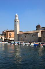 Fototapeta premium Lazise city is a small village on Lake Garda in Italy with a church and a small harbor with boats