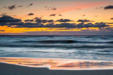 Naklejka premium A beautiful sunset on the beach of the Sobieszewo Island at the Baltic Sea. Poland