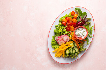 Healthy chopped salad with fresh vegetables, sprouts and sauce. Concept clean eating. Top view.
