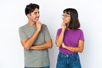 Young couple isolated on isolated white background looking looking at each other