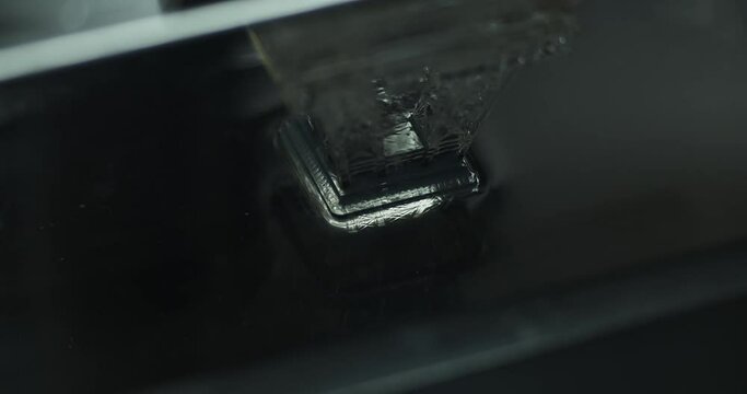 Side view Close up shot of resin MSLA 3D Printer printing anobject in clear resin with UV light