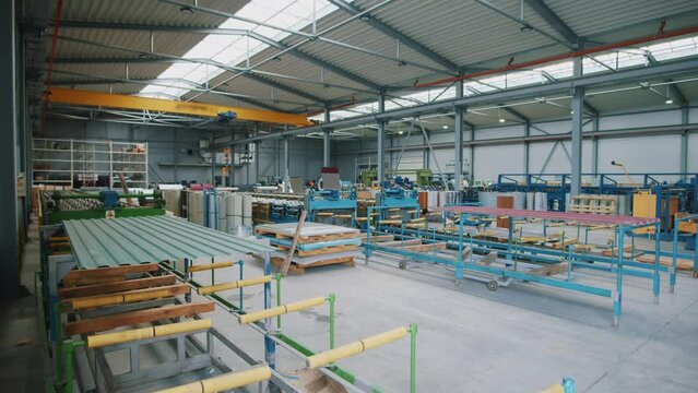 A large factory with metal. Lots of shelves in stock