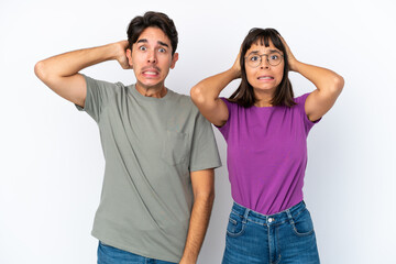 Young couple isolated on isolated white background takes hands on head because has migraine
