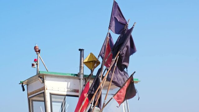 Fishing Net Flag Markers Stored Next to Fishing Vessel Steering Wheel House