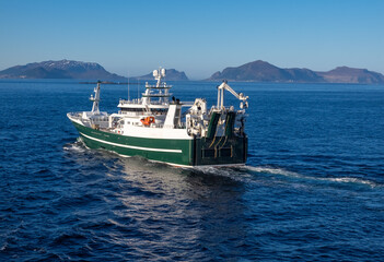 Fishing boat along the breathtaking fjords, skerries and islands of the Norwegian Western Coast near Ålesund, Møre og Romsdal, Norway.