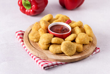 Delicious Crispy Fried Chicken Nuggets with Tomatoes Sauce on the Wooden Board Tasty Snack Gray Backfround Horizontal