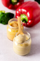 Glass Jars with Natural Baby Food on the Light Gray Background Vegetable Puree with Broccoli and...