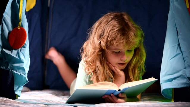 Happy childhood, dreaming child read bedtime stories, fairystory or fairytale. Kid boy reading books.