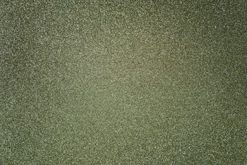 Silver green glitter twinkle abstract winter or Christmas holiday background with sparkles. Modern luxury mock up with sequins. Texture of colored porous rubber with spangles